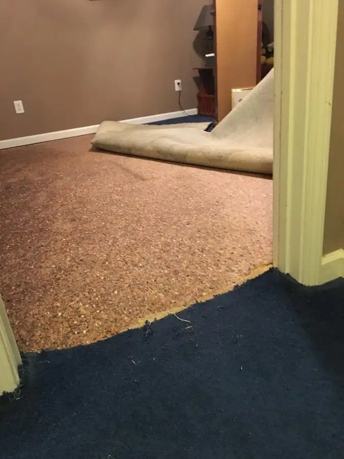 Carpet pad removal revealing water damage during Drying & Dehumidification in Clay